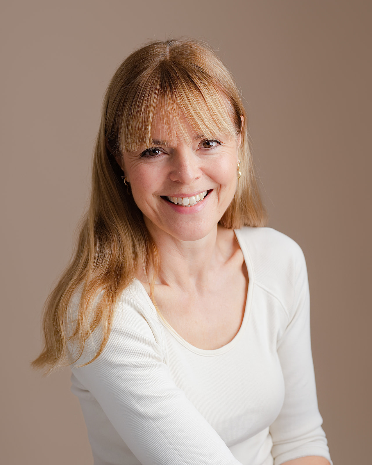 Caroline Sandry smiling during a professional photo shoot